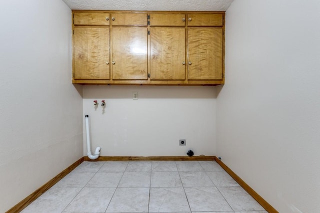 5718 Sheppard Rd, Baytown, TX 77521 - laundry room featuring cabinet space, electric dryer hookup, hookup for a washing machine, baseboards, and light tile patterned flooring