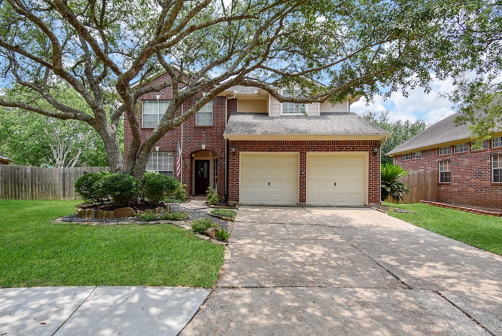 1111 Cambrian Park Ct, Sugar Land, TX 77479 - traditional home with driveway, brick siding, and an attached garage