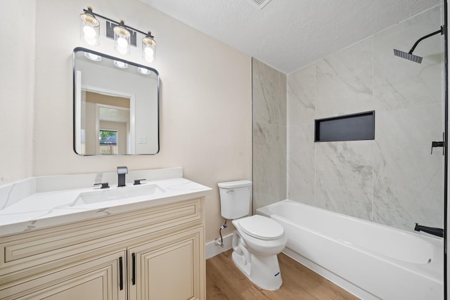11115 Maple Rock Dr, Humble, TX 77396 - full bath featuring wood finished floors, toilet, a textured ceiling, vanity, and shower / washtub combination
