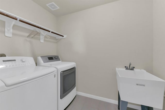 5335 Ivory Glass Dr, Katy, TX 77493 - washroom with washing machine and dryer, baseboards, and light tile patterned floors