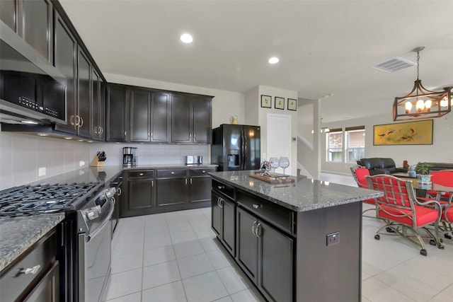 5335 Ivory Glass Dr, Katy, TX 77493 - kitchen with stainless steel appliances, decorative backsplash, light tile patterned floors, a chandelier, and recessed lighting