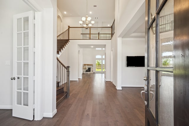 27403 Laurel Bay Ct, Katy, TX 77494 - entrance foyer with arched walkways, stairs, a chandelier, dark wood finished floors, and a towering ceiling