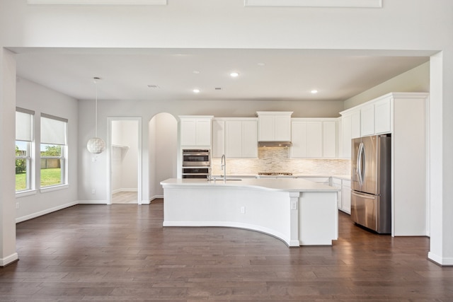 27403 Laurel Bay Ct, Katy, TX 77494 - kitchen featuring appliances with stainless steel finishes, recessed lighting, backsplash, an island with sink, and light countertops
