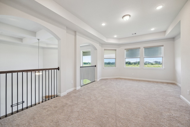 27403 Laurel Bay Ct, Katy, TX 77494 - carpeted spare room with recessed lighting, baseboards, a raised ceiling, and arched walkways