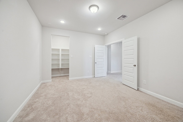 27403 Laurel Bay Ct, Katy, TX 77494 - unfurnished bedroom featuring a spacious closet, light colored carpet, baseboards, and recessed lighting