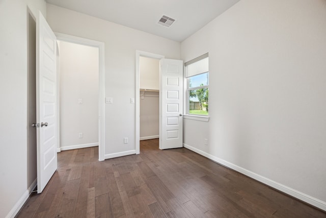 27403 Laurel Bay Ct, Katy, TX 77494 - unfurnished bedroom with dark wood-type flooring, baseboards, and a spacious closet