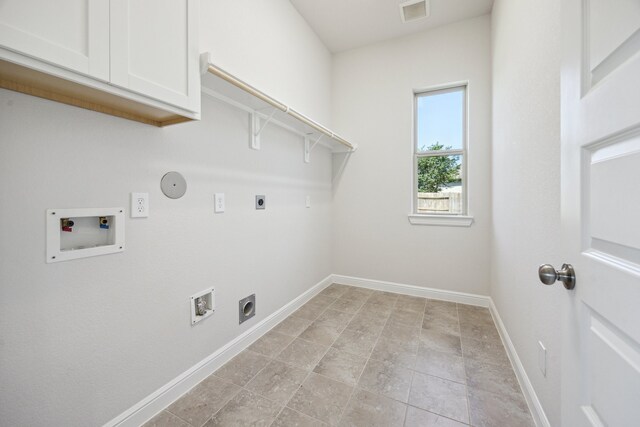 27403 Laurel Bay Ct, Katy, TX 77494 - washroom featuring cabinet space, hookup for an electric dryer, hookup for a washing machine, baseboards, and gas dryer hookup