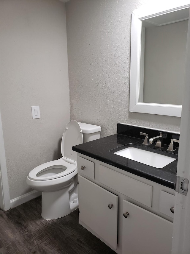 11710 Southlake Dr, Houston, TX 77077 - half bath featuring toilet, wood finished floors, vanity, and baseboards
