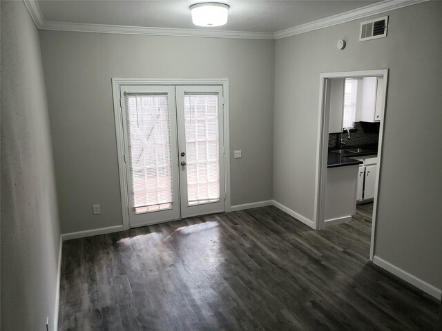 11710 Southlake Dr, Houston, TX 77077 - unfurnished dining area with french doors, crown molding, a sink, dark wood finished floors, and baseboards