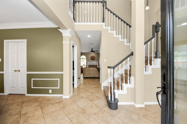 111 Knoll Forest Dr, Sugar Land, TX 77479 - entryway featuring a ceiling fan, ornamental molding, stairs, tile patterned flooring, and a fireplace