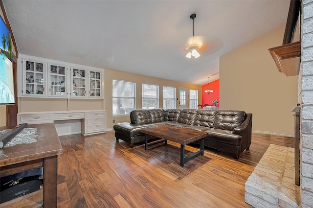 21226 Park Bend Dr, Katy, TX 77450 - living area featuring wood finished floors, vaulted ceiling, and baseboards