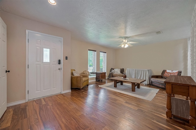 21226 Park Bend Dr, Katy, TX 77450 - foyer entrance featuring wood finished floors, ceiling fan, baseboards, and a textured ceiling