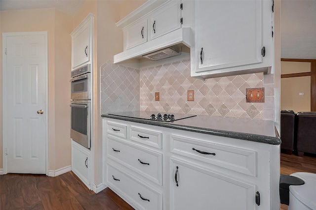 21226 Park Bend Dr, Katy, TX 77450 - kitchen featuring black electric cooktop, dark countertops, stainless steel double oven, dark wood-type flooring, and white cabinetry