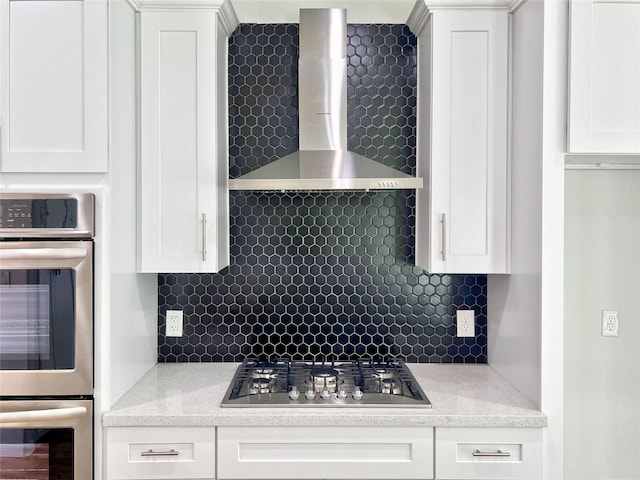 9630 Landry Blvd, Spring, TX 77379 - kitchen with stainless steel appliances, wall chimney exhaust hood, tasteful backsplash, and white cabinetry