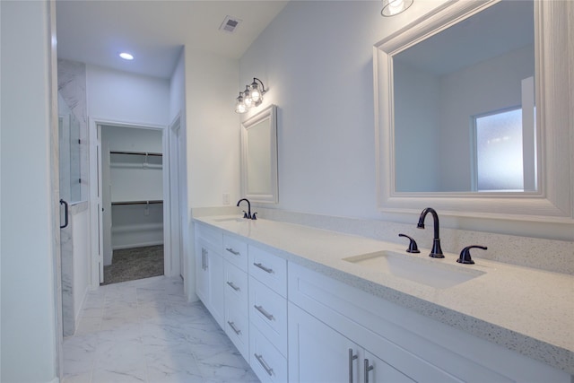 9630 Landry Blvd, Spring, TX 77379 - bathroom with marble look tile flooring, a spacious closet, double vanity, a stall shower, and recessed lighting