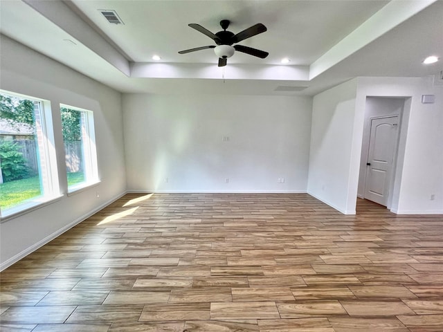 9630 Landry Blvd, Spring, TX 77379 - empty room with a raised ceiling, wood finished floors, a ceiling fan, baseboards, and recessed lighting