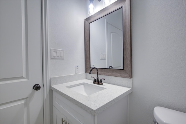 9630 Landry Blvd, Spring, TX 77379 - bathroom featuring vanity, a textured wall, and toilet
