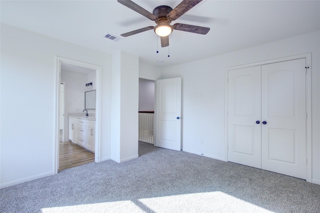 9630 Landry Blvd, Spring, TX 77379 - unfurnished bedroom featuring light colored carpet, baseboards, a closet, ensuite bath, and ceiling fan
