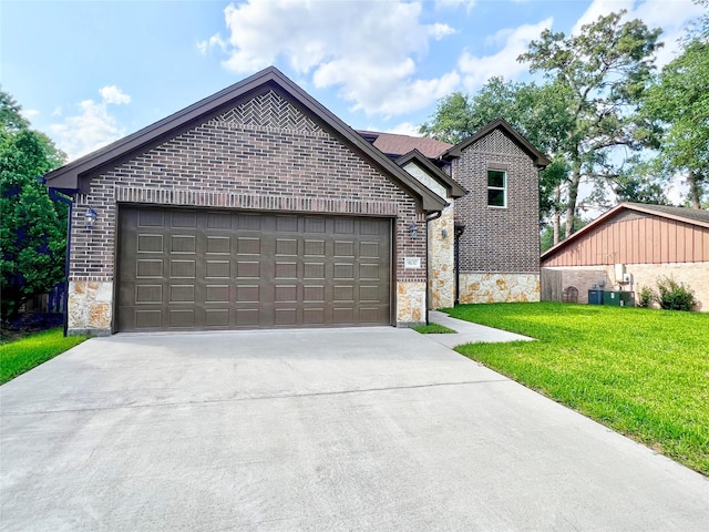 9630 Landry Blvd, Spring, TX 77379 - view of front facade featuring stone siding, driveway, a front lawn, and an attached garage