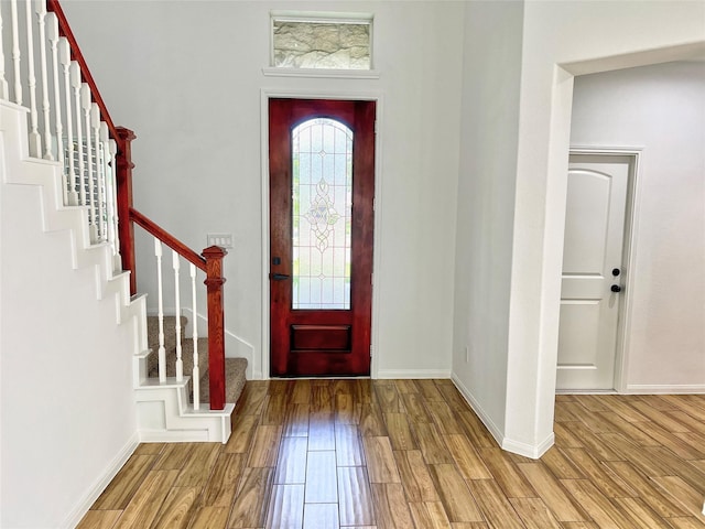 9630 Landry Blvd, Spring, TX 77379 - entryway with wood finished floors, stairs, and baseboards