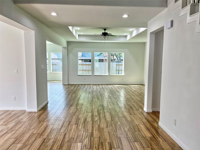 9630 Landry Blvd, Spring, TX 77379 - unfurnished room with a raised ceiling, a ceiling fan, wood finished floors, healthy amount of natural light, and recessed lighting