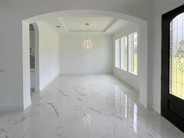 126 Lakeland Cir, Rosharon, TX 77583 - entryway with a raised ceiling, baseboards, light marble finish floors, arched walkways, and a chandelier