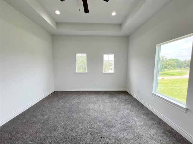 126 Lakeland Cir, Rosharon, TX 77583 - spare room with a ceiling fan, dark carpet, a tray ceiling, baseboards, and recessed lighting