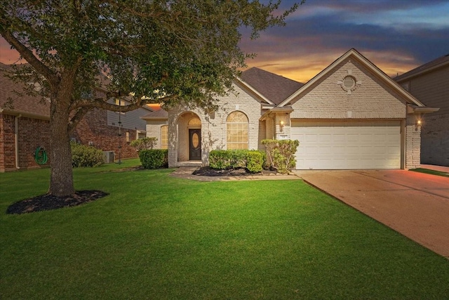 14 Mira Loma Dr, Manvel, TX 77578 - view of front of property with concrete driveway, an attached garage, a lawn, brick siding, and cooling unit