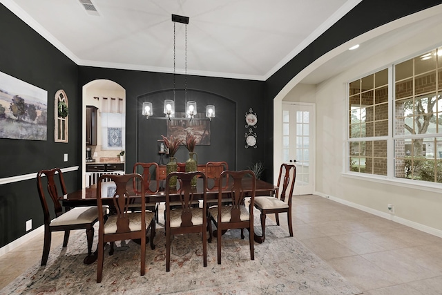 14023 Loramie Creek Ct, Houston, TX 77044 - tiled dining area featuring arched walkways, a chandelier, crown molding, and baseboards