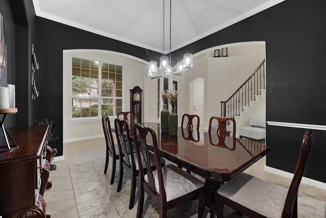 14023 Loramie Creek Ct, Houston, TX 77044 - dining area featuring arched walkways, a chandelier, baseboards, stairway, and ornamental molding