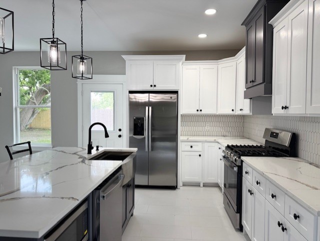 2235 Minnesota St, Houston, TX 77034 - kitchen featuring stainless steel appliances, a sink, backsplash, recessed lighting, and pendant lighting