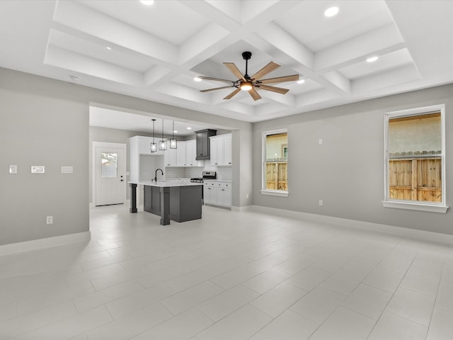 2235 Minnesota St, Houston, TX 77034 - kitchen with open floor plan, a sink, light countertops, coffered ceiling, and a center island with sink