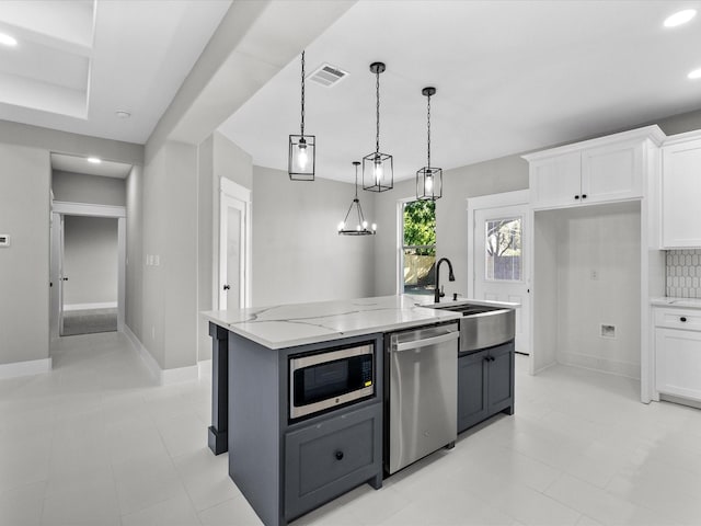 2235 Minnesota St, Houston, TX 77034 - kitchen featuring stainless steel appliances, a sink, white cabinets, light stone counters, and recessed lighting