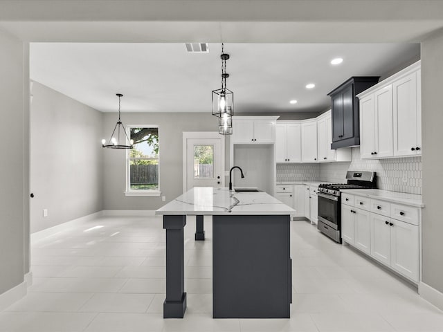 2235 Minnesota St, Houston, TX 77034 - kitchen featuring stainless steel gas stove, light stone countertops, a sink, baseboards, and tasteful backsplash