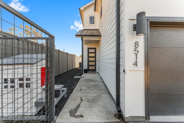 8514 W St, Houston, TX 77093 - view of side of home with a standing seam roof, metal roof, and fence