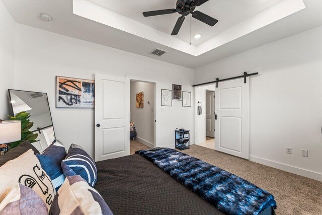 8514 W St, Houston, TX 77093 - carpeted bedroom with a barn door, a raised ceiling, baseboards, recessed lighting, and ceiling fan