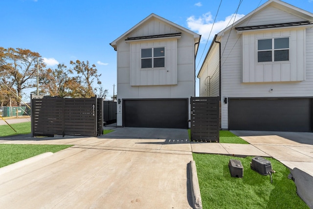 8514 W St, Houston, TX 77093 - view of front of property featuring an attached garage, board and batten siding, fence, and driveway