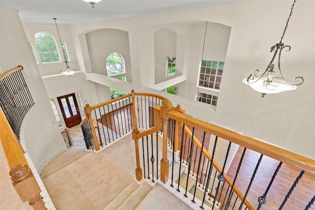 14306 Medlowe Ct, Cypress, TX 77429 - staircase with baseboards, a towering ceiling, and arched walkways