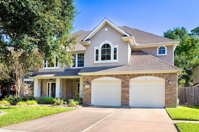 14306 Medlowe Ct, Cypress, TX 77429 - view of front of home with driveway, roof with shingles, a garage, stucco siding, and brick siding