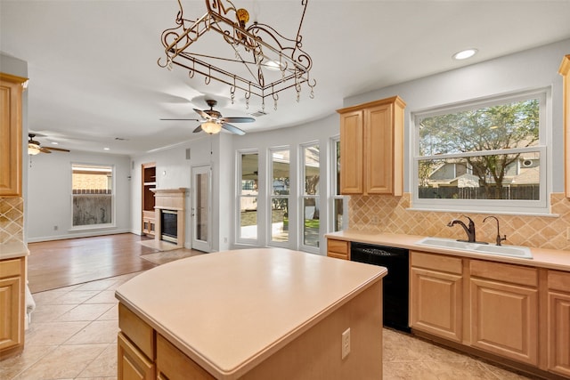 14306 Medlowe Ct, Cypress, TX 77429 - kitchen with black dishwasher, a sink, a ceiling fan, a glass covered fireplace, and recessed lighting