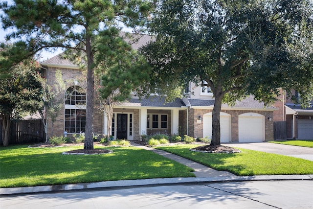 14306 Medlowe Ct, Cypress, TX 77429 - view of property hidden behind natural elements featuring concrete driveway, brick siding, a shingled roof, and a garage
