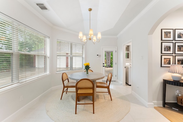 6 Cranberry Bnd, The Woodlands, TX 77381 - dining room featuring arched walkways, a chandelier, light tile patterned floors, crown molding, and baseboards