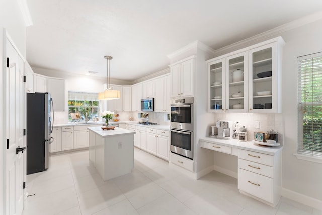 6 Cranberry Bnd, The Woodlands, TX 77381 - kitchen featuring appliances with stainless steel finishes, tasteful backsplash, light countertops, white cabinets, and ornamental molding