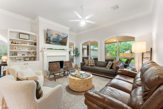 6 Cranberry Bnd, The Woodlands, TX 77381 - living room featuring ceiling fan, ornamental molding, a fireplace, and built in shelves