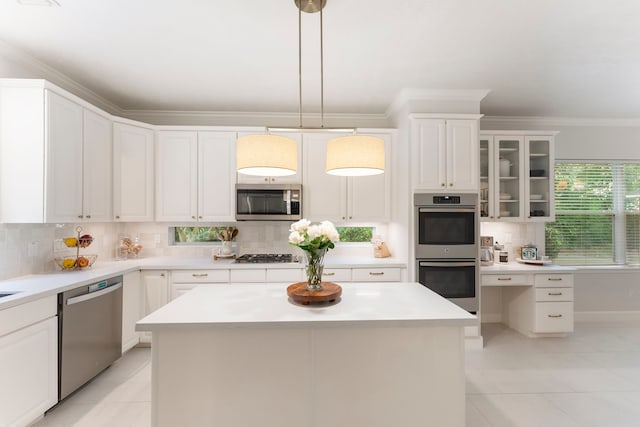6 Cranberry Bnd, The Woodlands, TX 77381 - kitchen with stainless steel appliances, tasteful backsplash, light tile patterned floors, white cabinetry, and ornamental molding