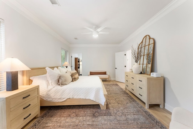 6 Cranberry Bnd, The Woodlands, TX 77381 - bedroom with ornamental molding, a ceiling fan, light wood-type flooring, and baseboards