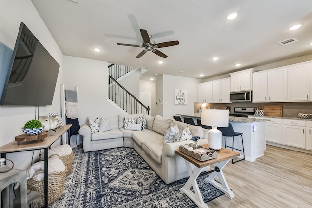 12738 Beatrice Terrace Dr, Humble, TX 77346 - living area featuring stairway, ceiling fan, recessed lighting, and light wood-style flooring