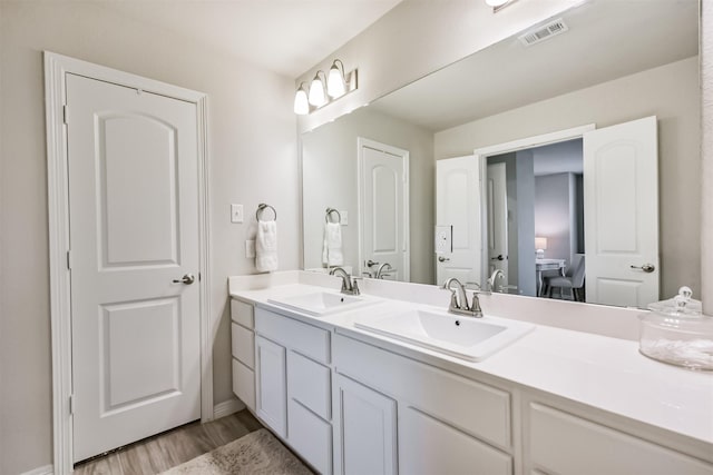 12738 Beatrice Terrace Dr, Humble, TX 77346 - bathroom with double vanity, wood finished floors, and baseboards