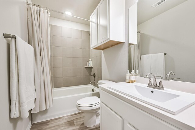12738 Beatrice Terrace Dr, Humble, TX 77346 - full bath featuring toilet, shower / tub combo with curtain, wood finished floors, vanity, and recessed lighting