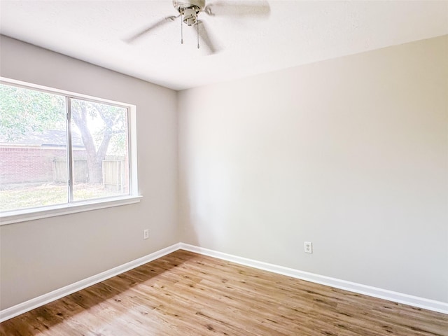 5422 Quail Cove Ln, Houston, TX 77053 - spare room featuring light wood-style floors, baseboards, and ceiling fan